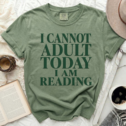 Green t-shirt with "I Cannot Adult Today I Am Reading" text.