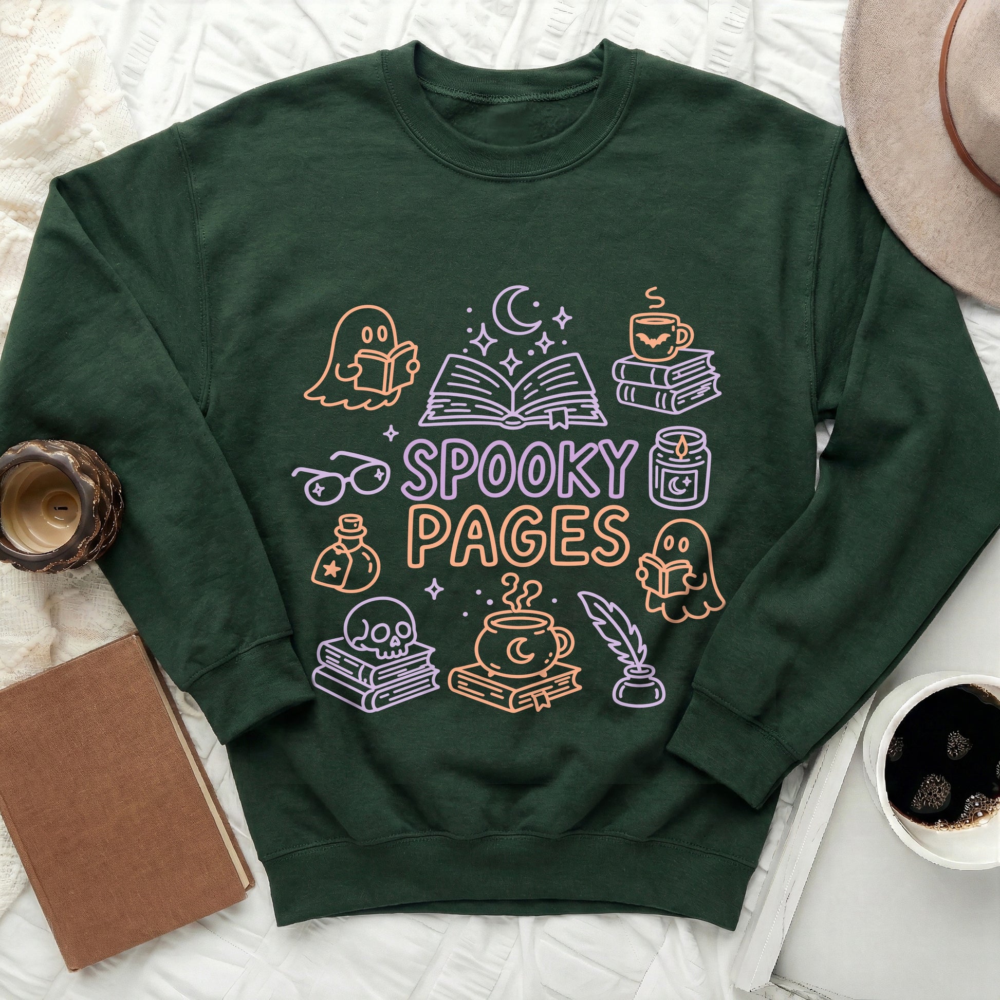 Green sweatshirt with "Spooky Pages" text and Halloween themed book illustrations.