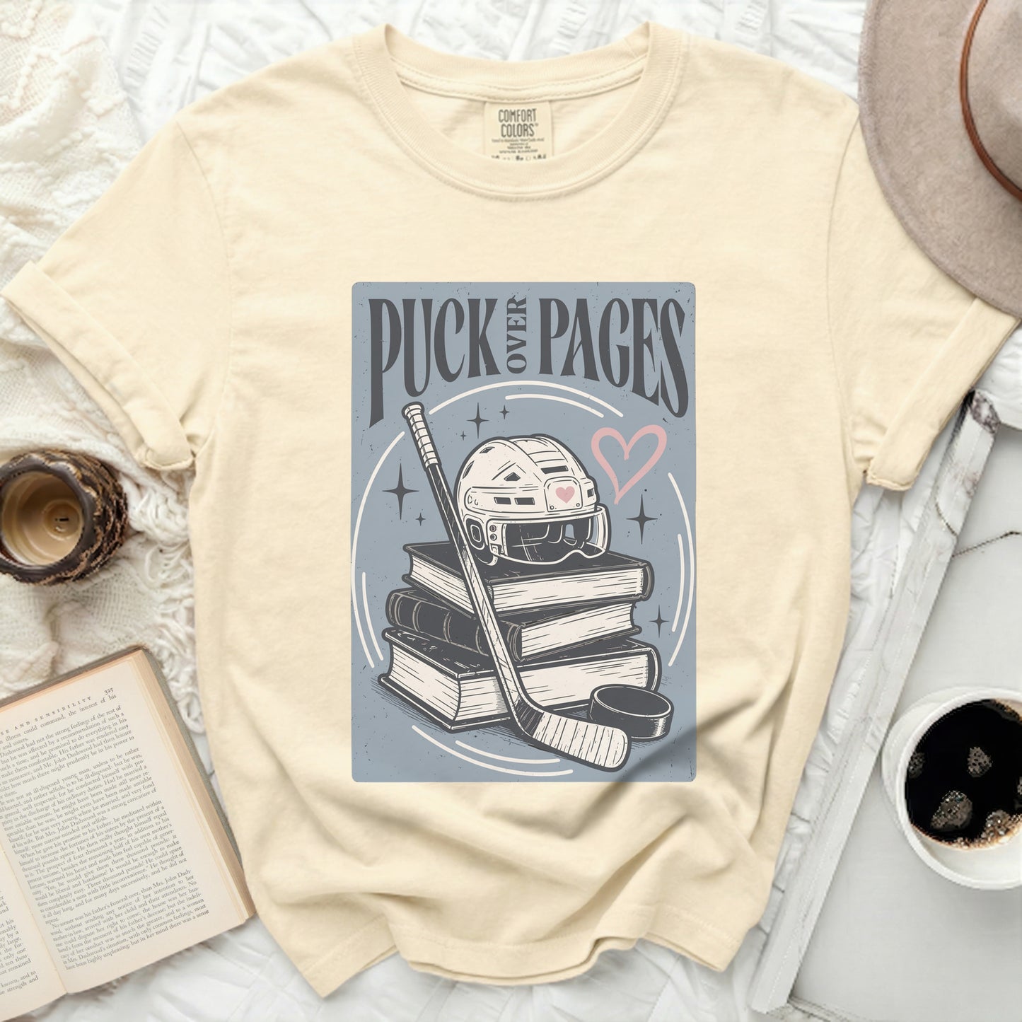 Comfort Colors t-shirt with "Puck Over Pages" hockey design.