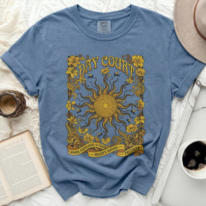 Blue t-shirt with yellow sun and floral design, "DAY COURT" and "WHERE KNOWLEDGE IS POWER" text.