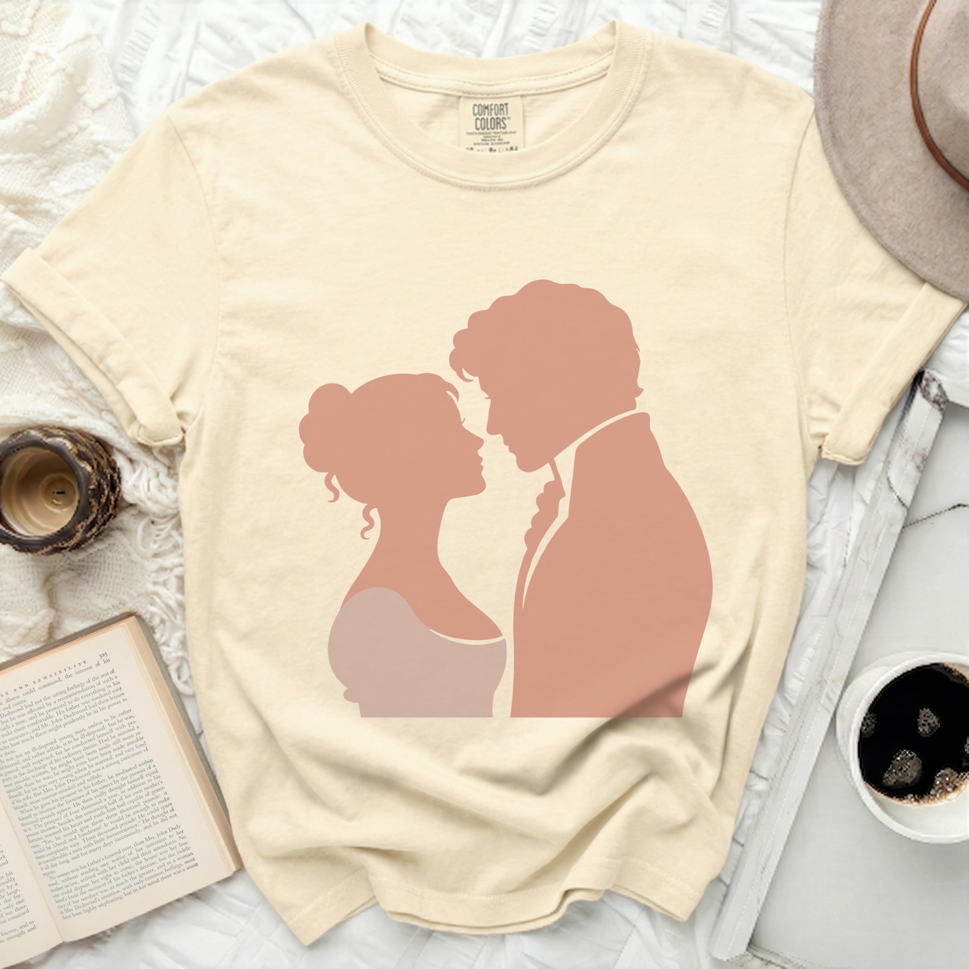 Cream t-shirt with peach silhouette of a couple looking at each other.