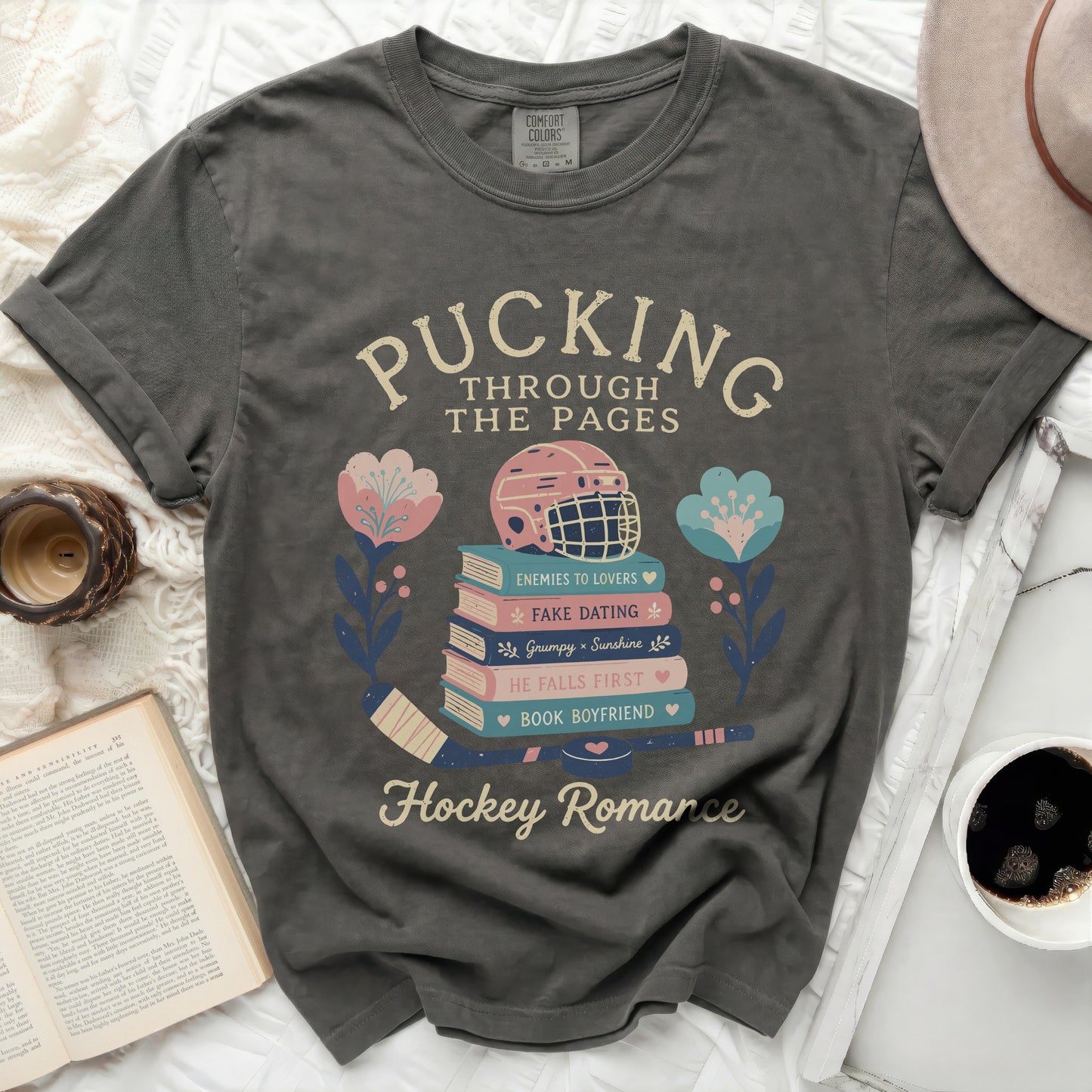 Dark t-shirt with "Pucking Through The Pages" and hockey romance themes.