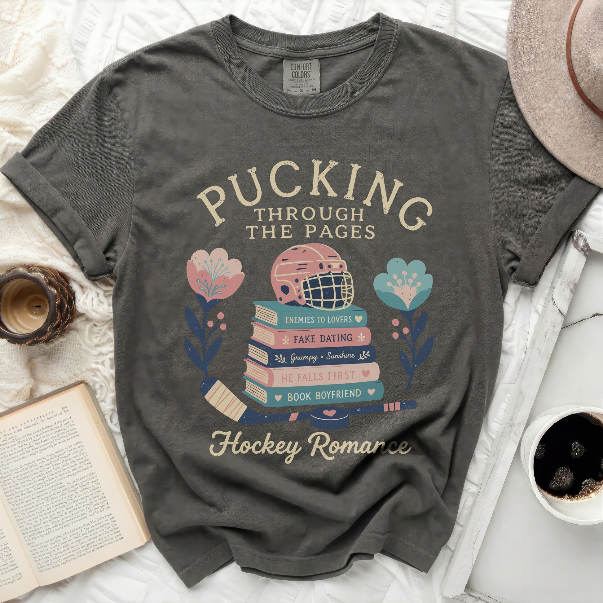 Dark t-shirt with "Pucking Through The Pages" and hockey romance themes.