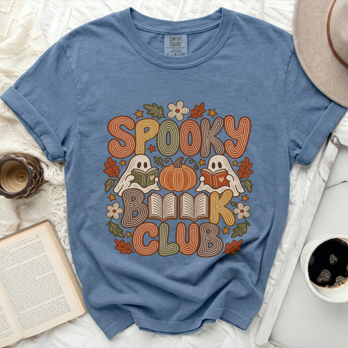 Blue t-shirt with "Spooky Book Club" text and ghost and pumpkin graphics.