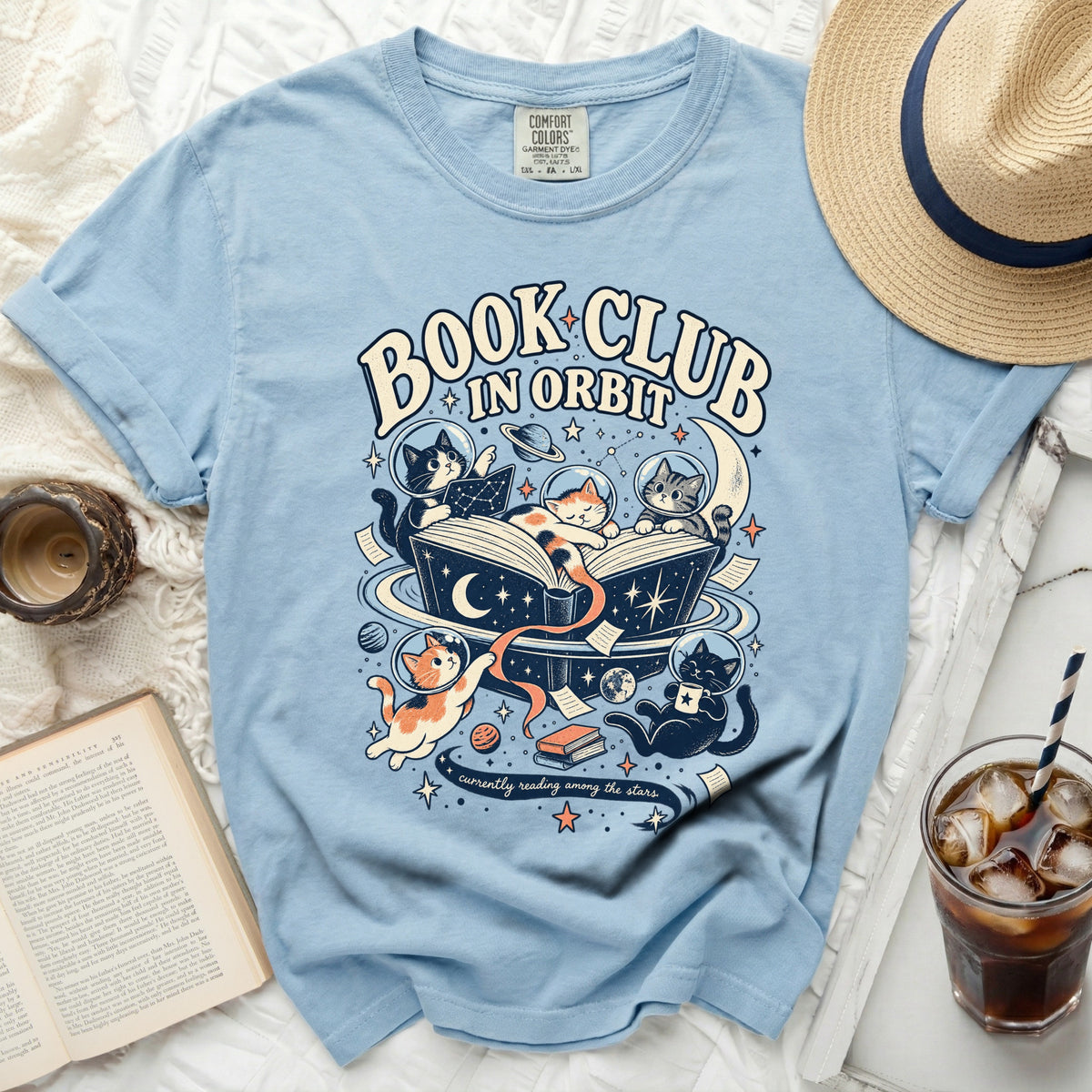 Light blue t-shirt with "Book Club In Orbit" text and cats in space graphic.