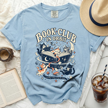 Light blue t-shirt with "Book Club In Orbit" text and cats in space graphic.