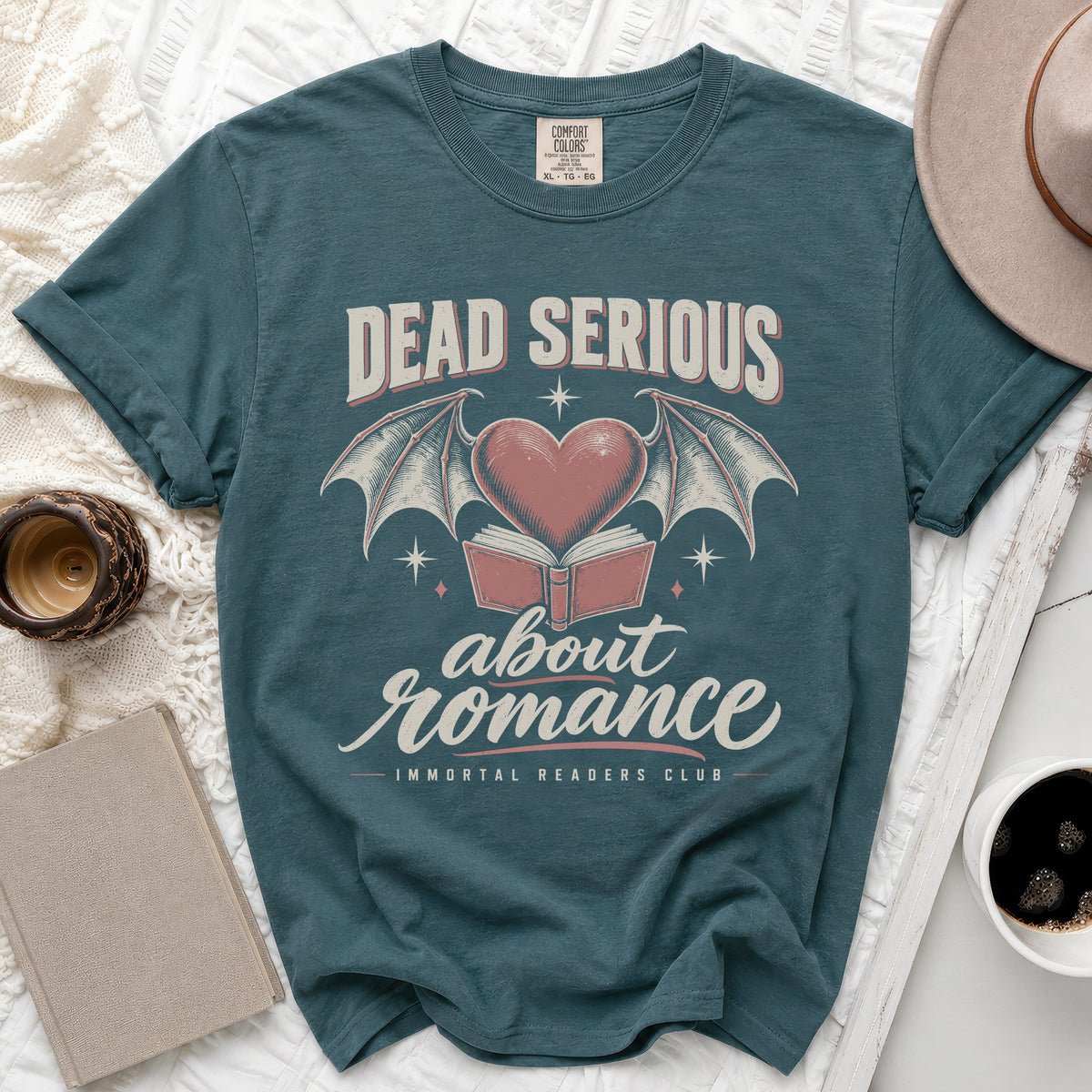 Teal t-shirt with "Dead Serious about romance" text and gothic heart design.