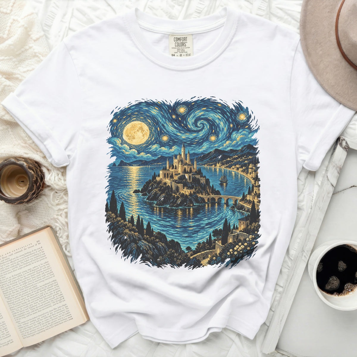 White t-shirt with a castle by the sea under a starry sky design.