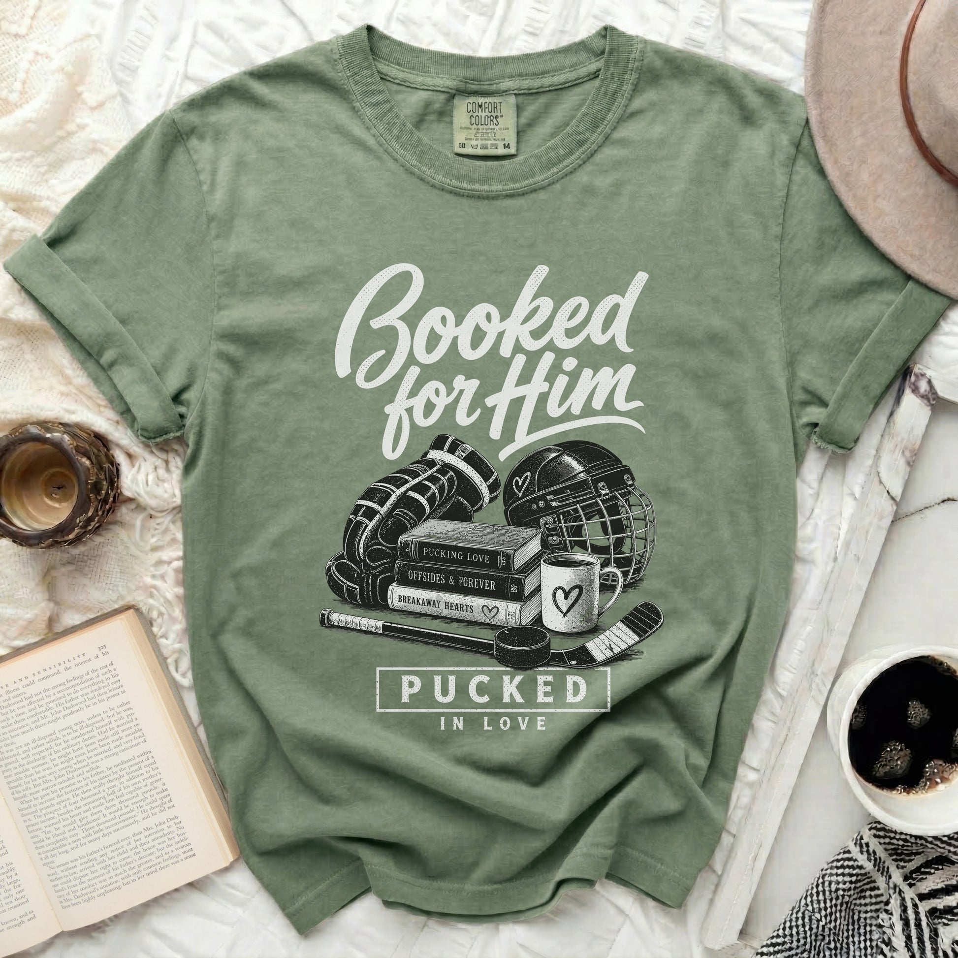 Green t-shirt with "Booked for Him" and hockey gear graphic.