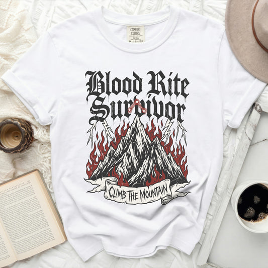 White t-shirt with "Blood Rite Survivor" and "Climb the Mountain" graphic.