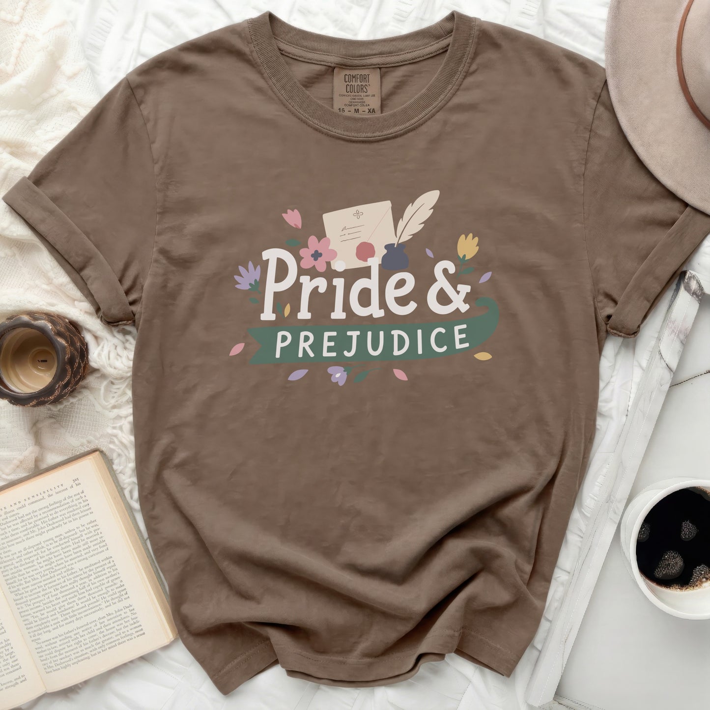 Brown t-shirt with "Pride & Prejudice" text and floral accents.