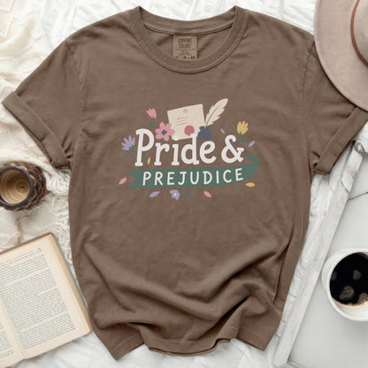Brown t-shirt with "Pride & Prejudice" text and floral accents.