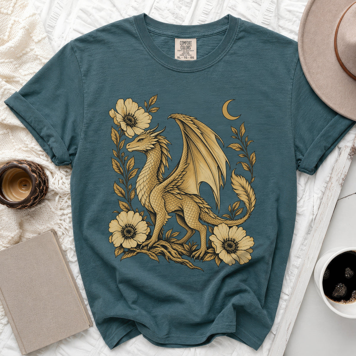 Teal t-shirt with a gold dragon surrounded by flowers and a crescent moon.