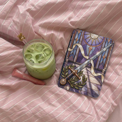 Glass of matcha latte and Rhode lip balm next to a tarot card.