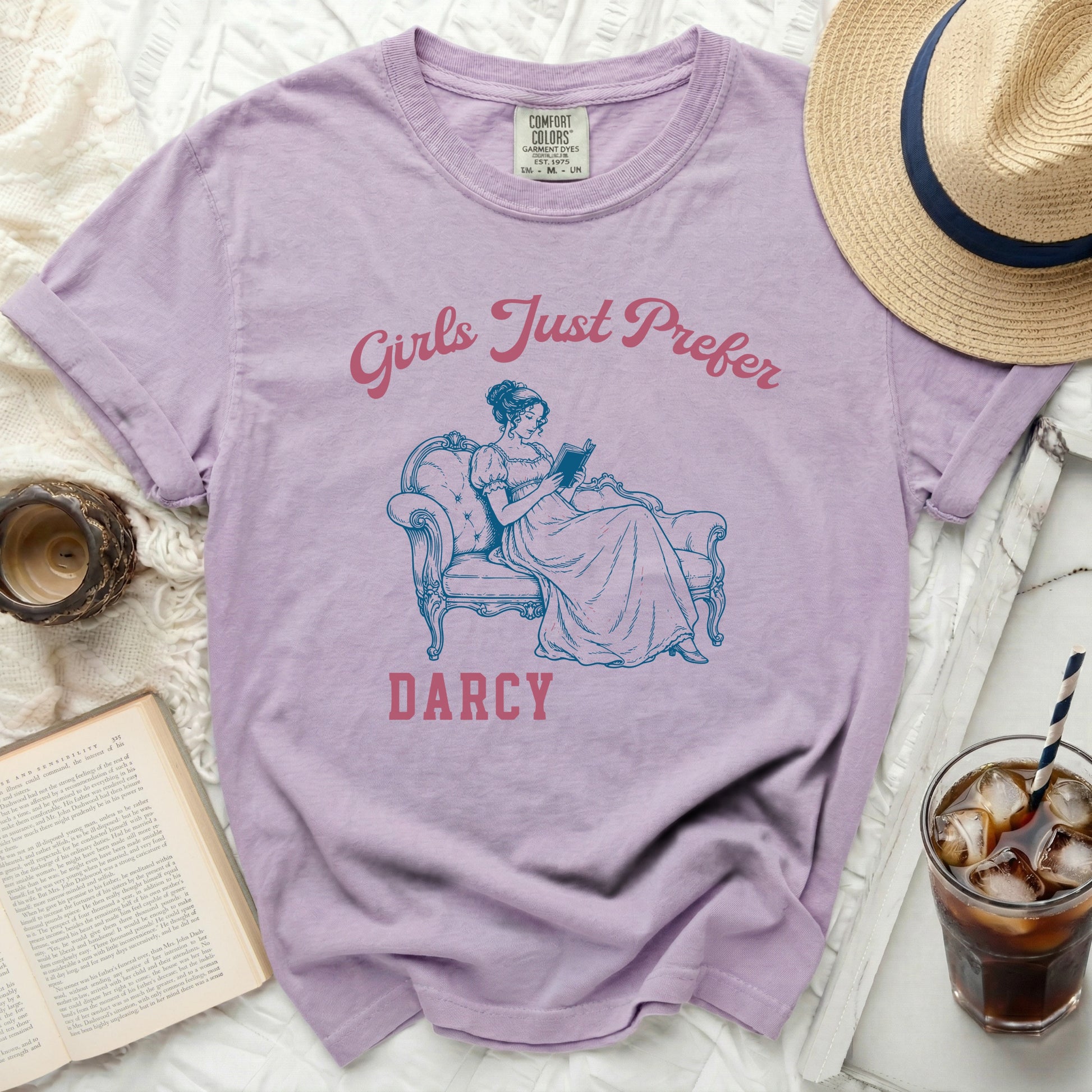Purple t-shirt with "Girls Just Prefer Darcy" and a woman reading.