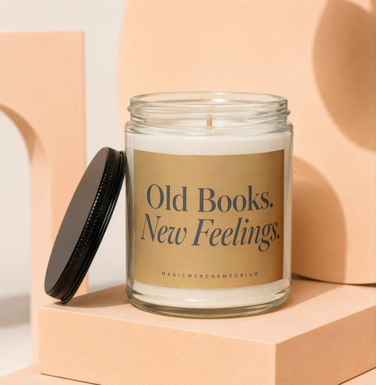 Glass candle with gold label reading "Old Books. New Feelings."