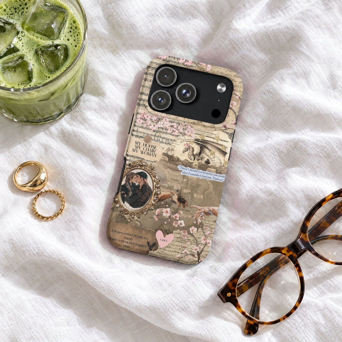 Fantasy-themed phone case with a vintage collage design, featuring dragons, romance quotes, and pink cherry blossoms on white fabric.
