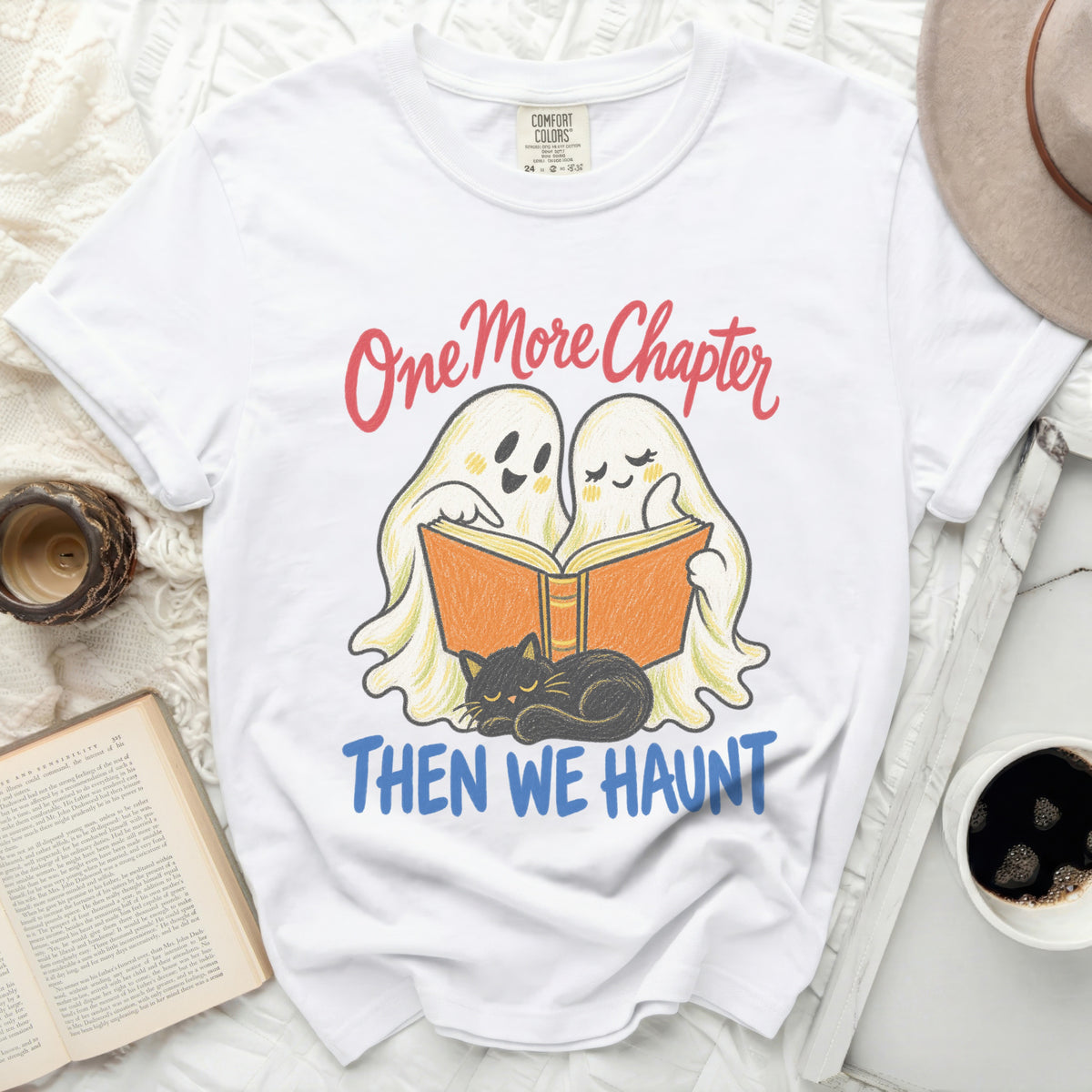White t-shirt with ghosts reading a book and "One More Chapter THEN WE HAUNT" text.