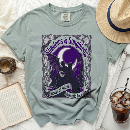 Green t-shirt with "Shadows & Songbirds House of Wind Acoustic Tour" graphic.