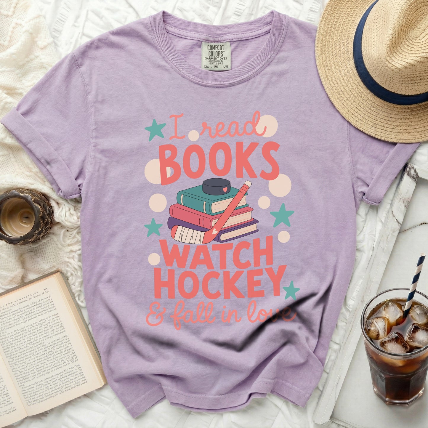 Purple t-shirt with "I read books, watch hockey & fall in love" graphic.
