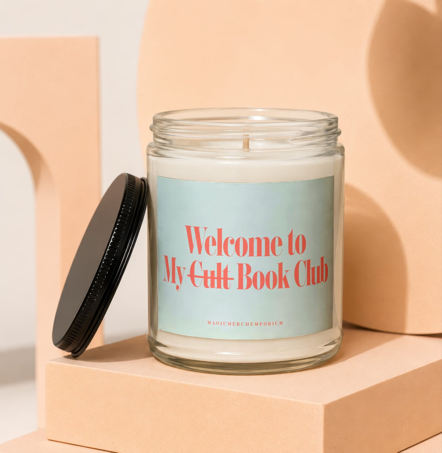 Glass candle with black lid and label reading "Welcome to My Cult Book Club"