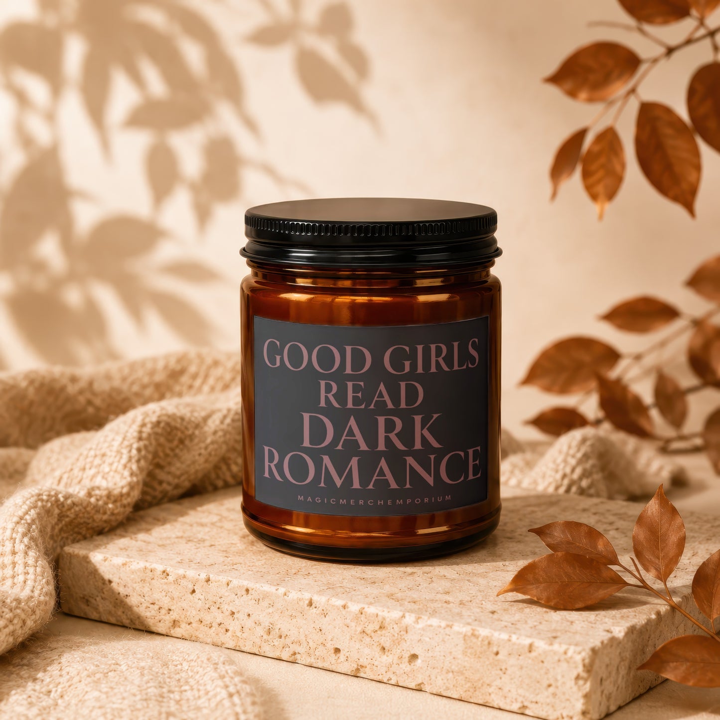 Amber jar candle with black lid, label reads "GOOD GIRLS READ DARK ROMANCE".