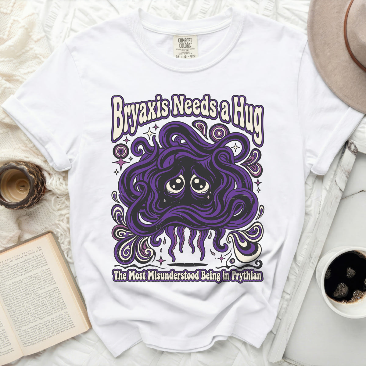 White t-shirt with purple graphic of a sad, tentacled creature and text.