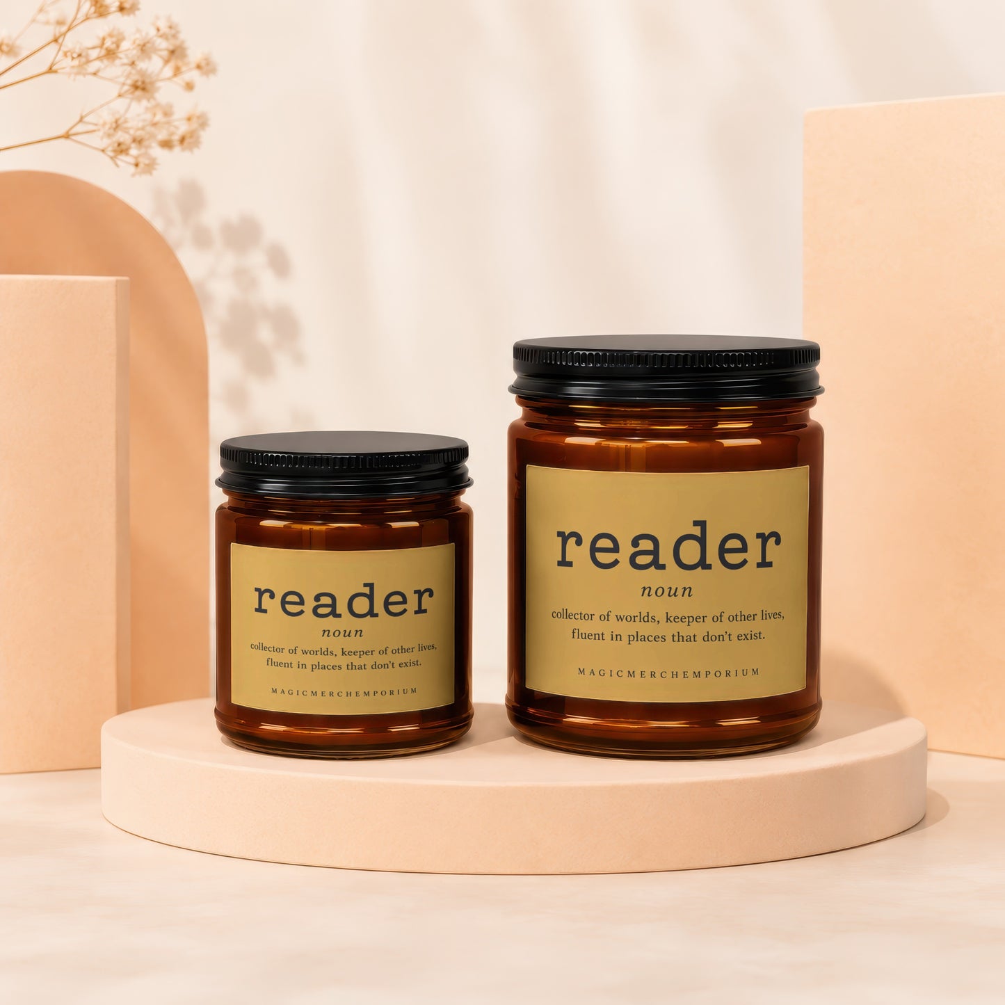 Two amber glass candles with "reader" labels, one small, one large.
