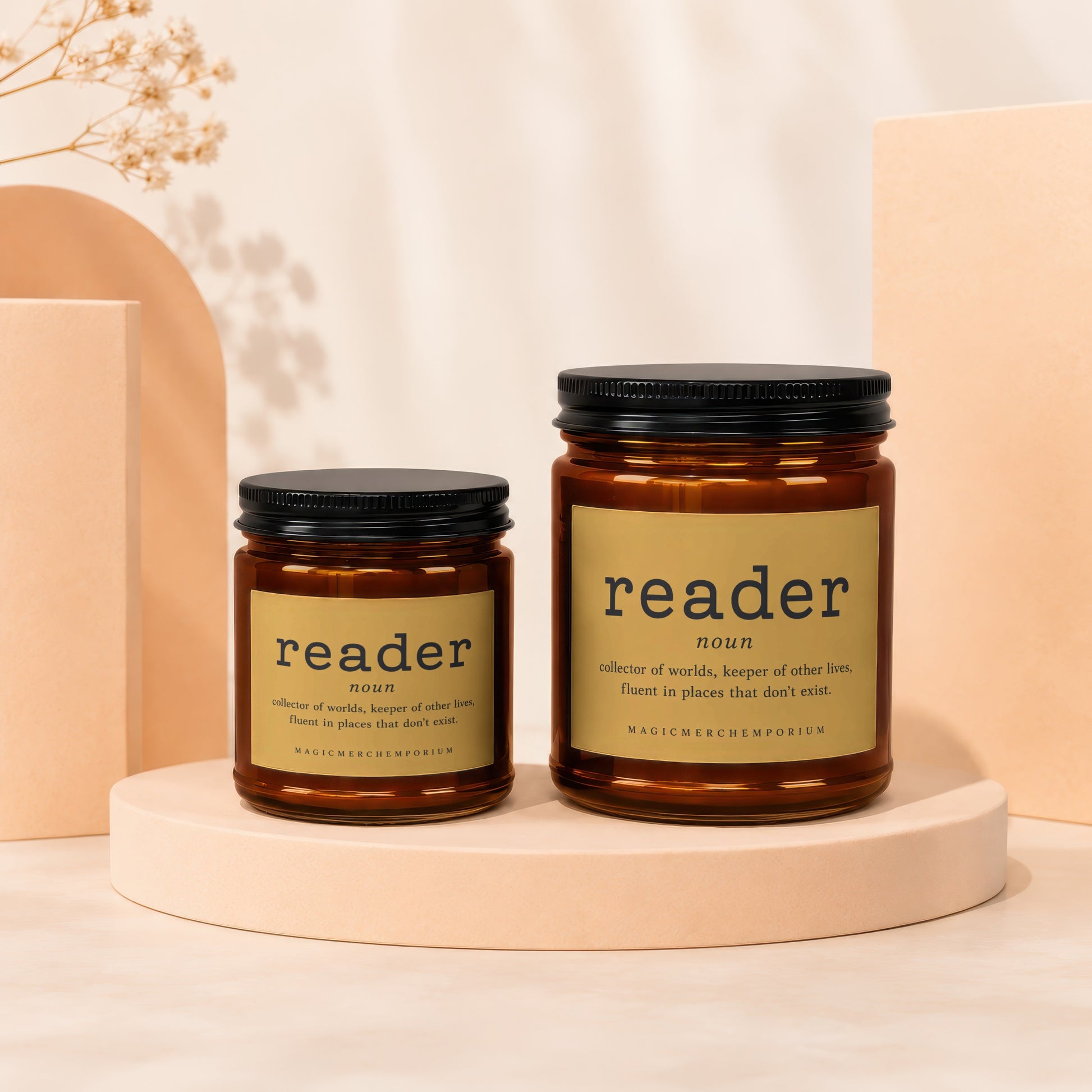 Two amber glass candles with "reader" labels, one small, one large.