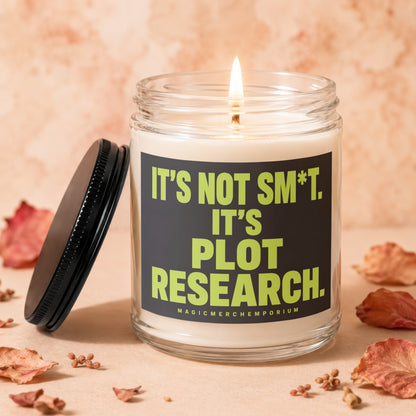 Lit candle in glass jar with "It's not sm*t. It's plot research." text.