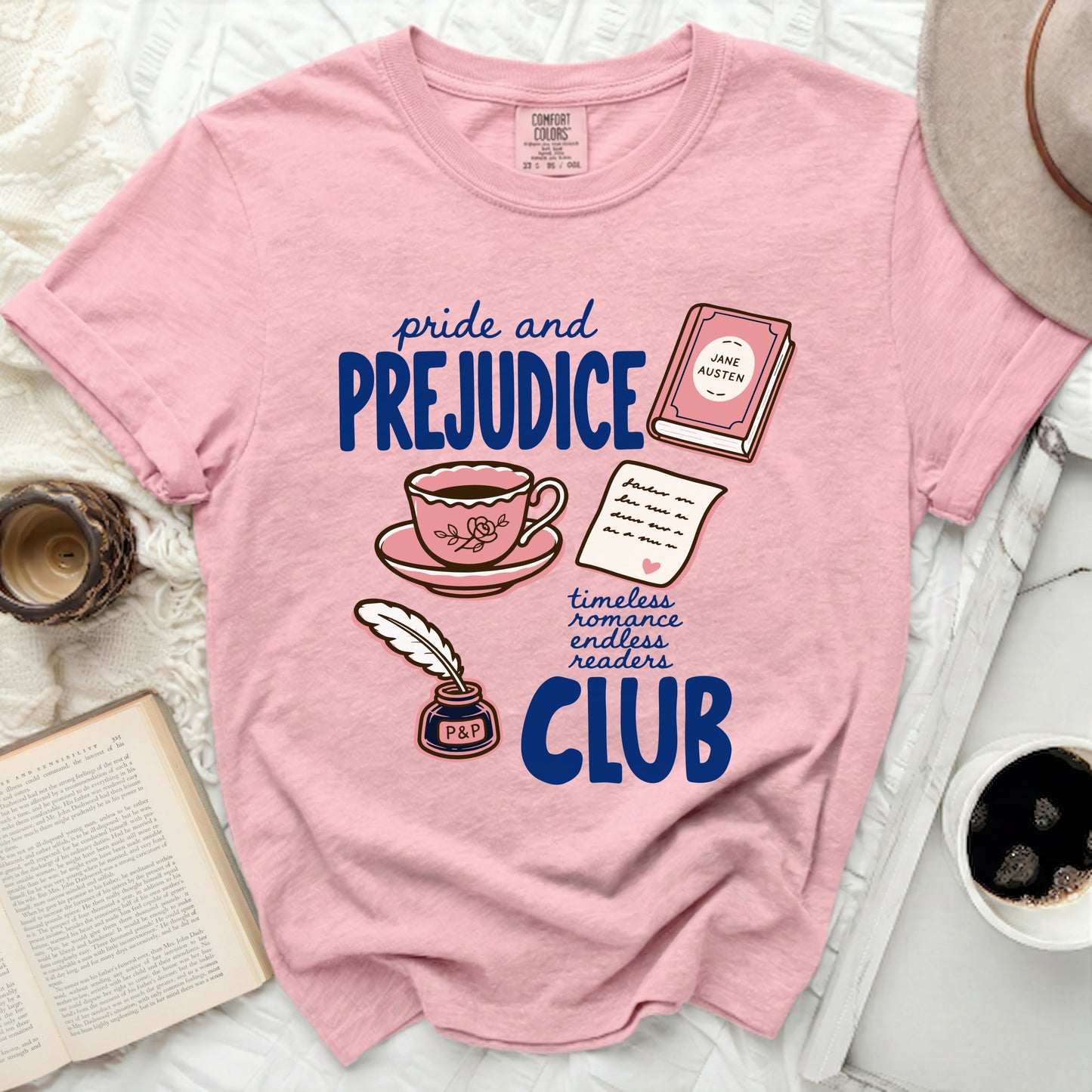 Pink t-shirt with "Pride and Prejudice Club" graphic and literary icons.