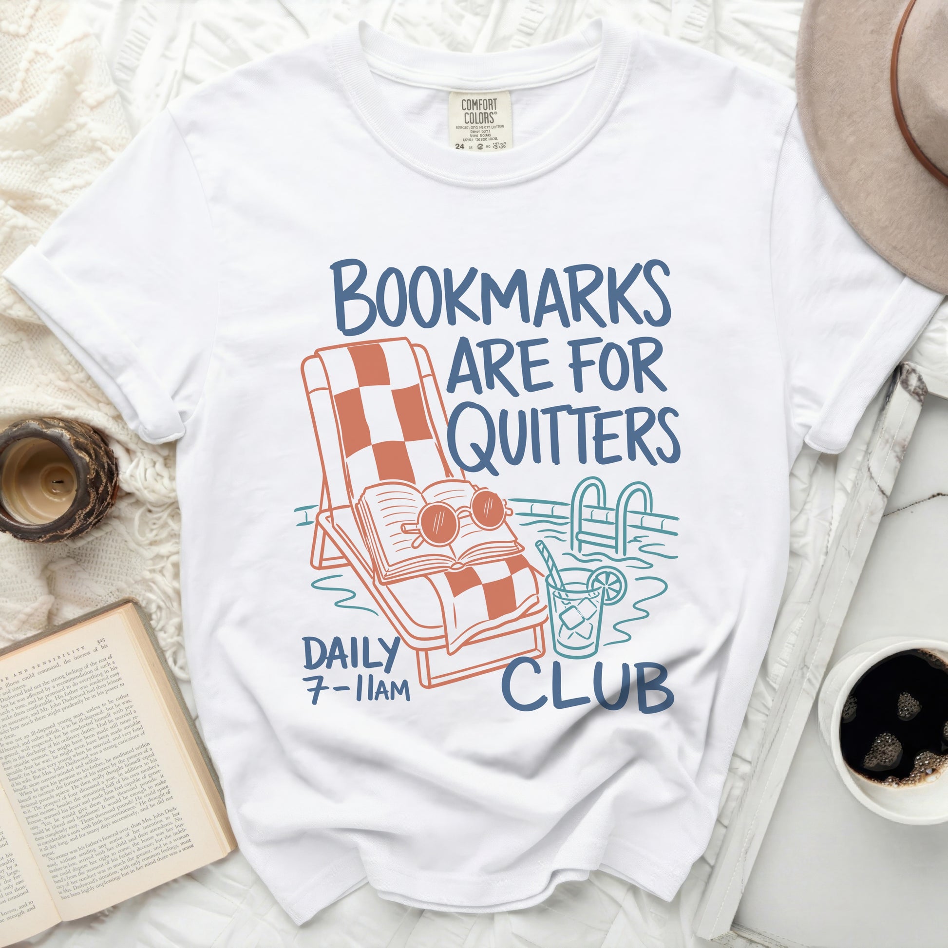 White t-shirt with "Bookmarks Are For Quitters Club" text and pool graphic.
