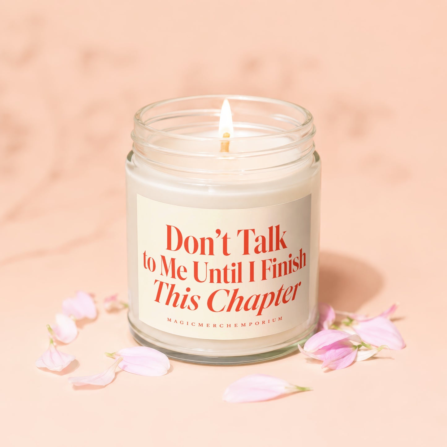 Lit candle in a glass jar with the text "Don't Talk to Me Until I Finish This Chapter".