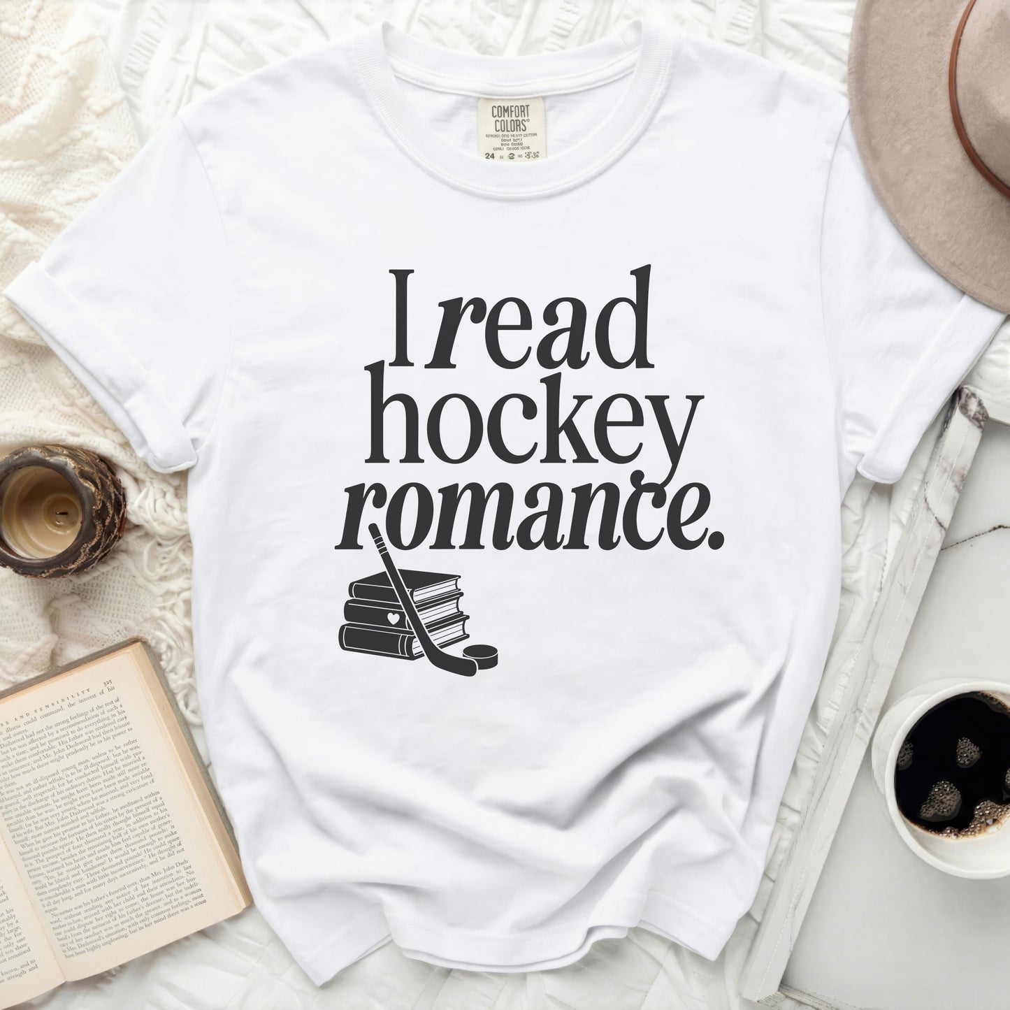 White t-shirt with "I read hockey romance." text and stacked books.