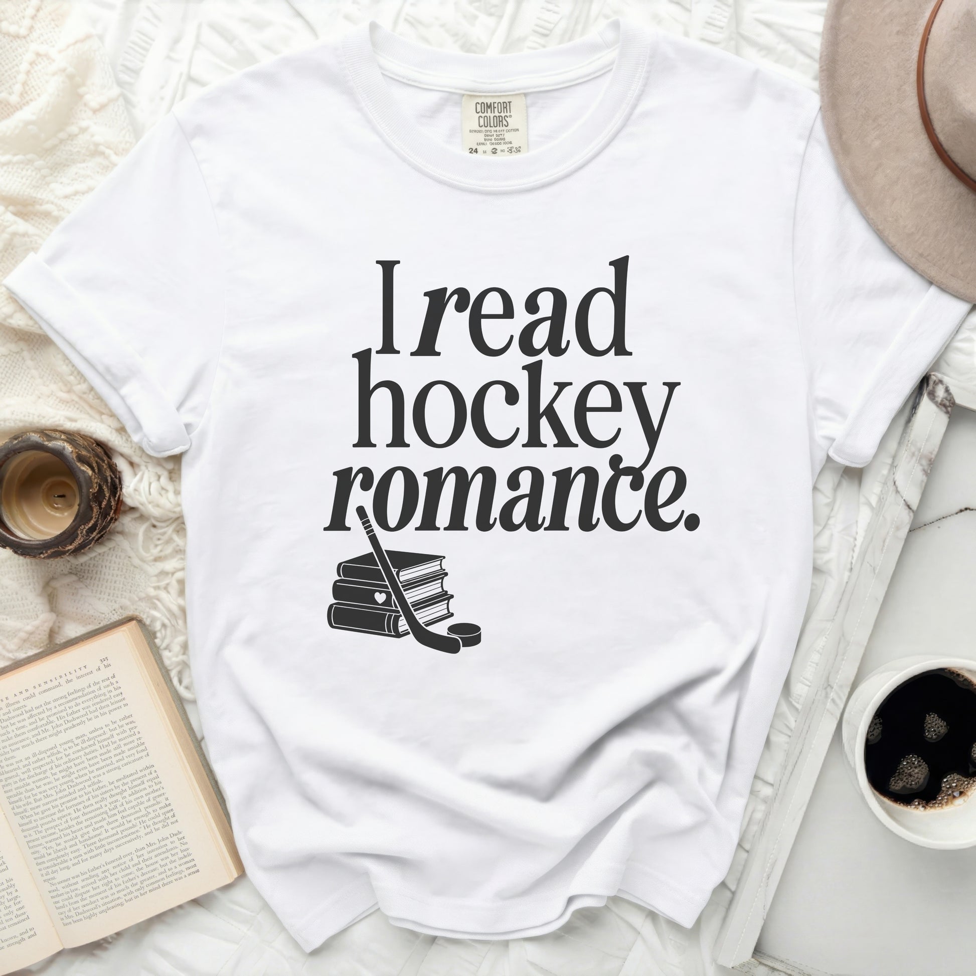 White t-shirt with "I read hockey romance." text and stacked books.