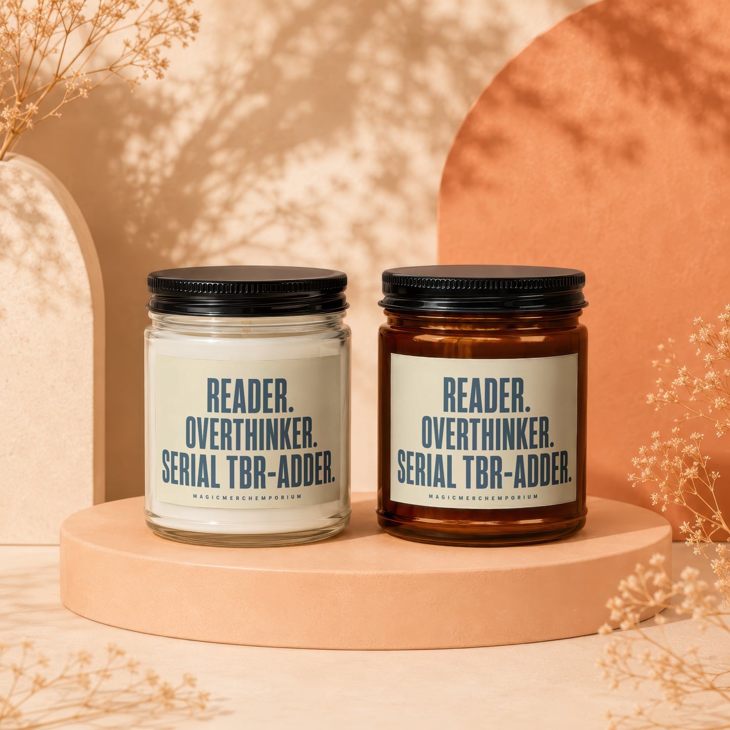 Two scented candles, one clear and one amber, with labels stating "Reader. Overthinker. Serial TBR-Adder."
