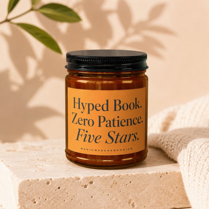 Amber candle with black lid, "Hyped Book. Zero Patience. Five Stars." text.