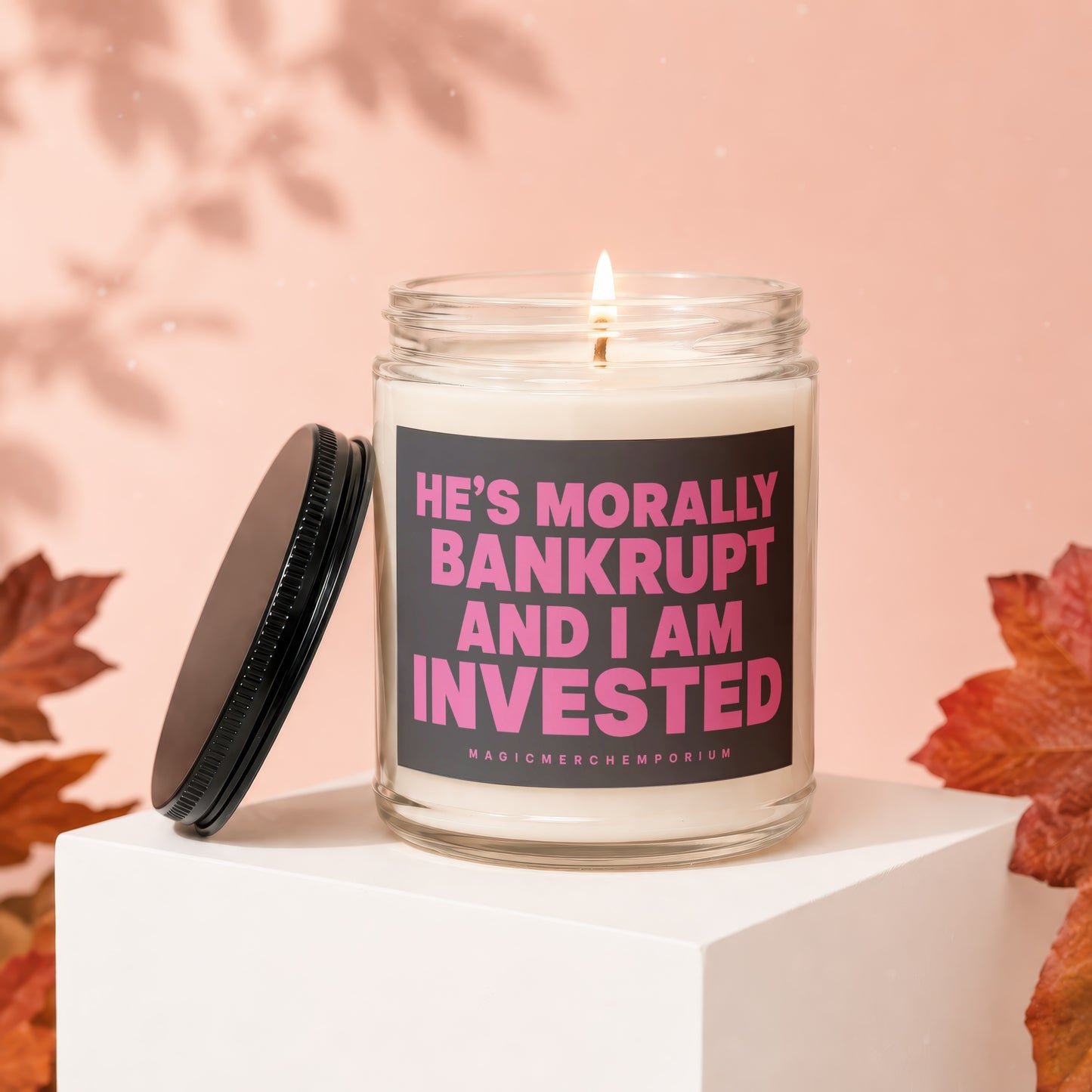 Candle with text "HE'S MORALLY BANKRUPT AND I AM INVESTED."