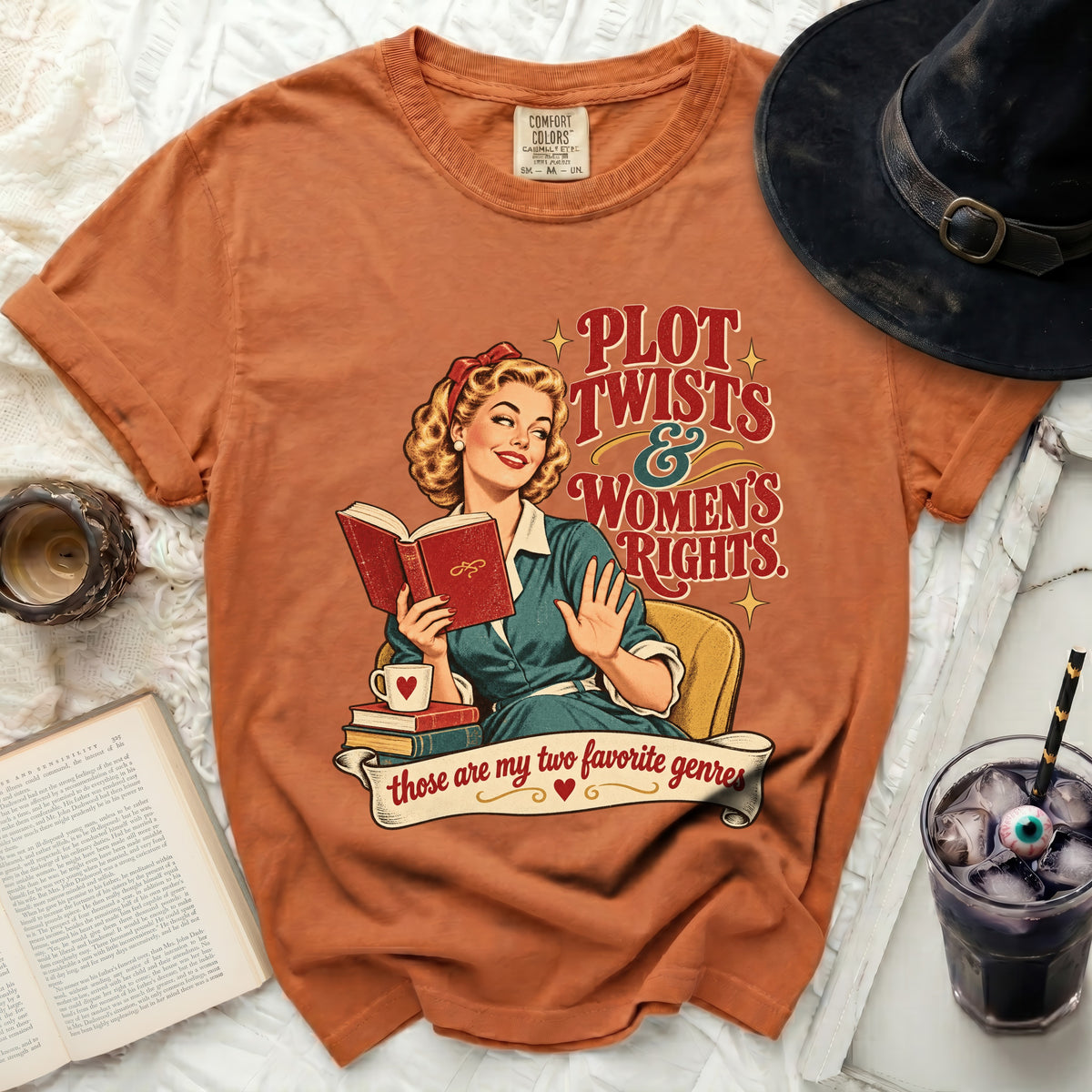 T-shirt with "Plot Twists & Women's Rights" graphic and retro woman reading.