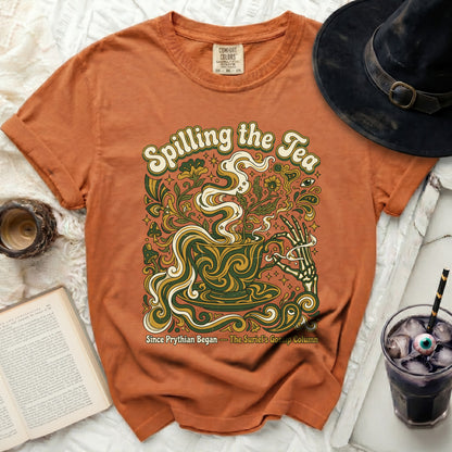 Orange t-shirt with "Spilling the Tea" and vintage graphic.