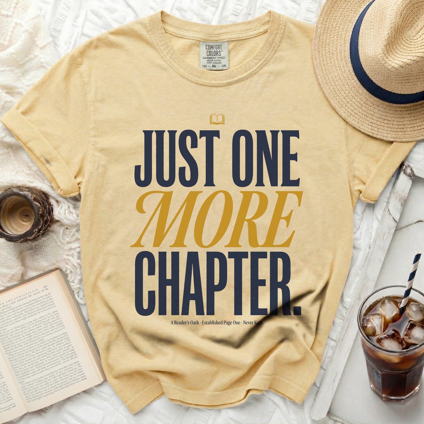 Yellow t-shirt with "JUST ONE MORE CHAPTER" in blue and gold.