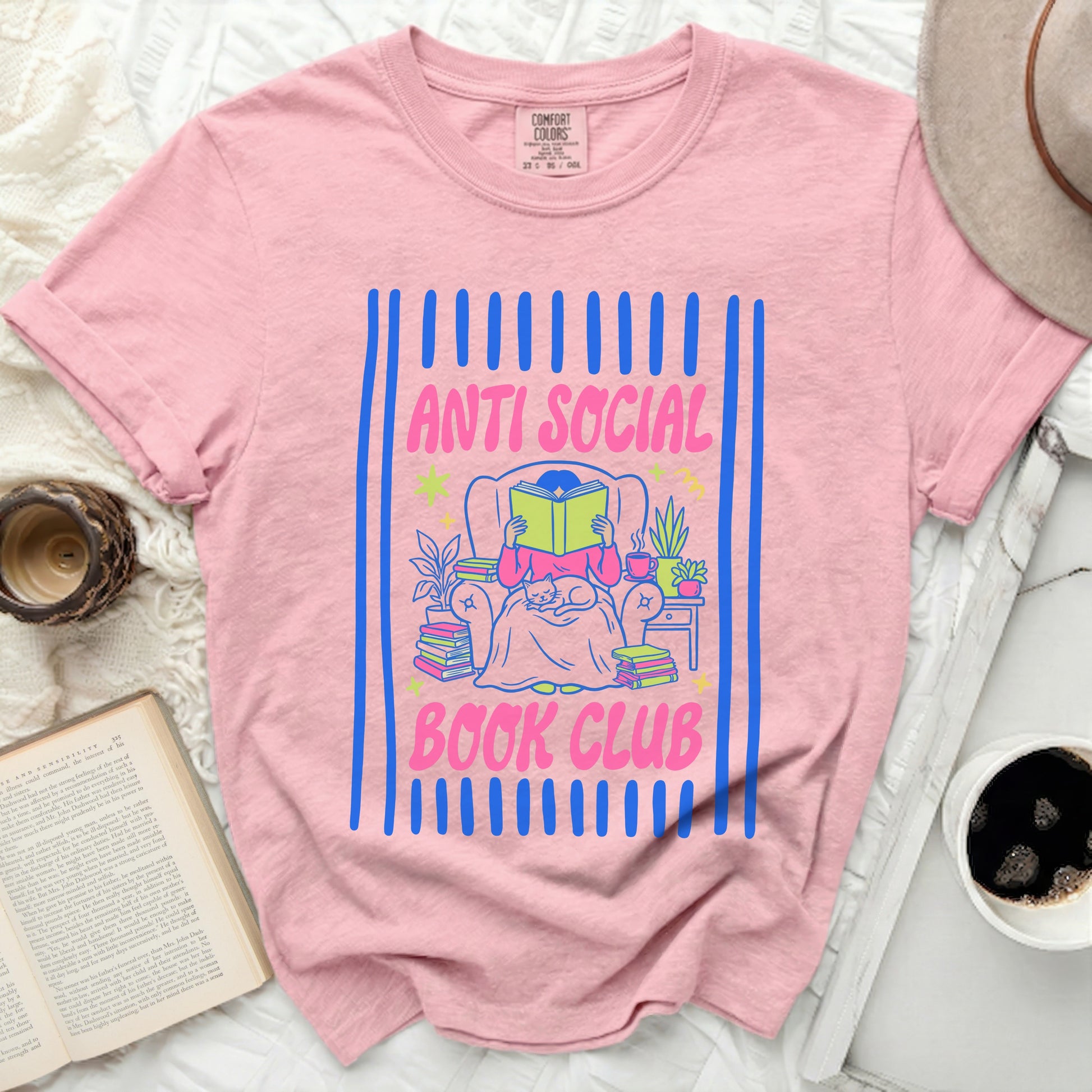 Pink t-shirt with "Anti Social Book Club" text and a person reading.
