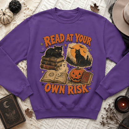 Purple sweatshirt with Halloween graphic reading "Read at Your Own Risk".