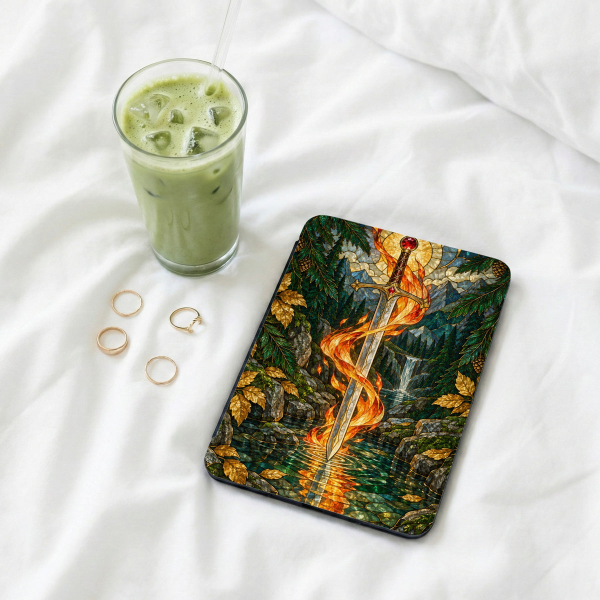 Tablet cover featuring a sword engulfed in flames over a forest waterfall.