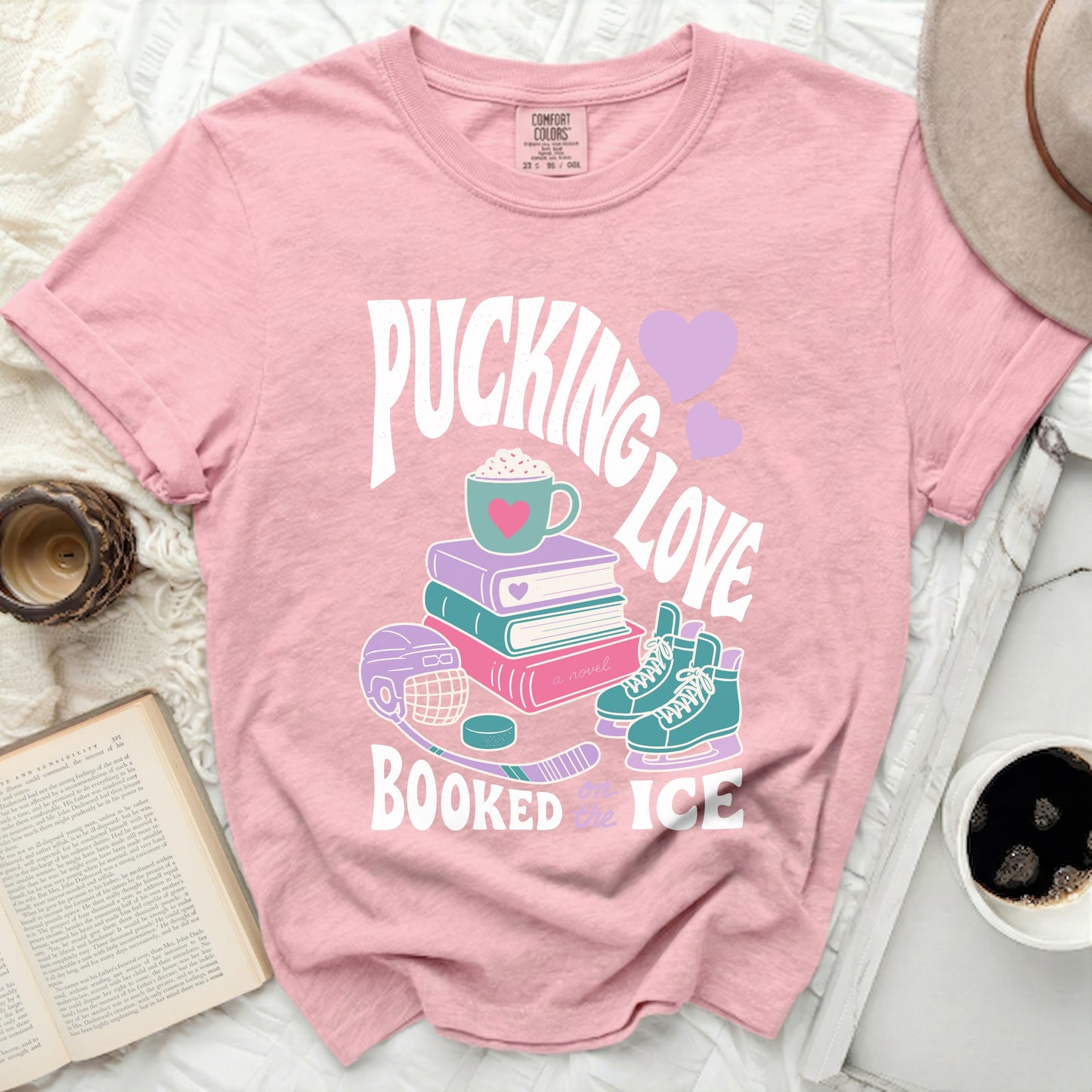 Pink t-shirt with "Pucking Love Booked Ice" text and hockey graphics.