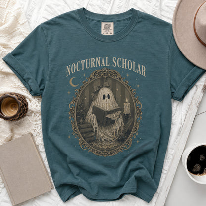 Teal t-shirt with "Nocturnal Scholar" in text and a ghost reading a book design.