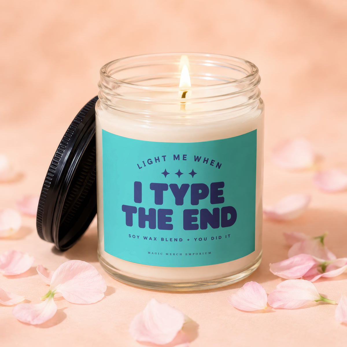 Soy wax candle with teal label reading "Light me when I type the end."