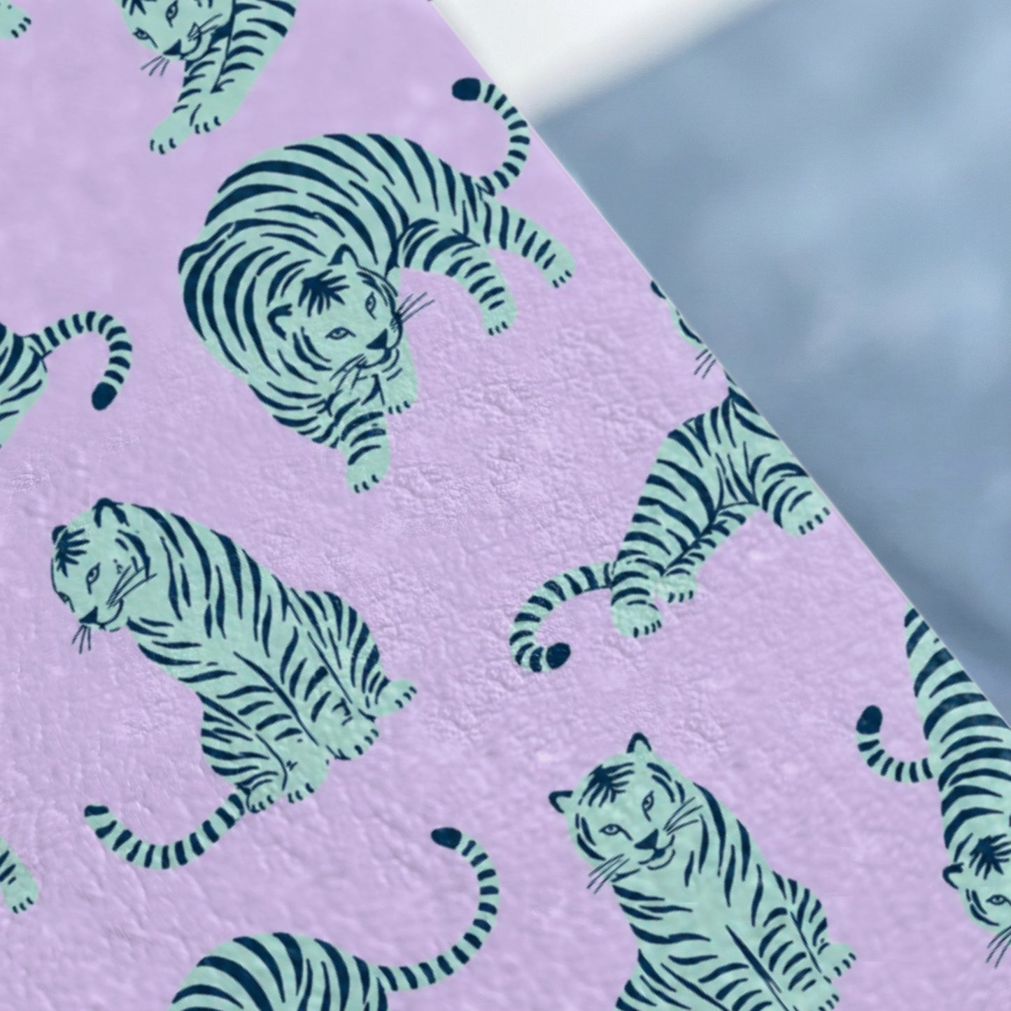 Pattern of stylized tigers in teal and navy on a lavender background.