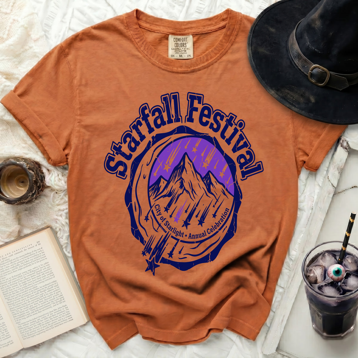 Orange t-shirt with "Starfall Festival City of Starlight Annual Celebration" graphic.