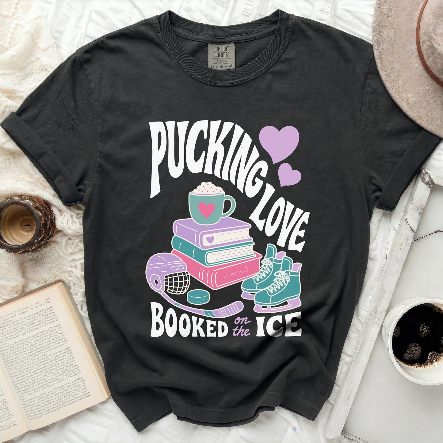 Dark t-shirt with "Pucking Love Booked on the Ice" text and hockey graphics.